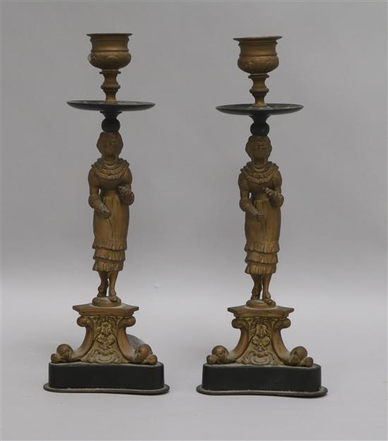 A pair of 19th century French bronze and ormolu figural candlesticks